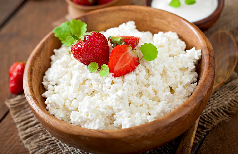 a bowl of cottage cheese topped with strawberries