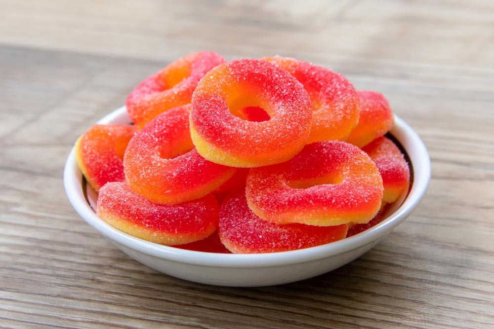 a bowl of peach gummy rings