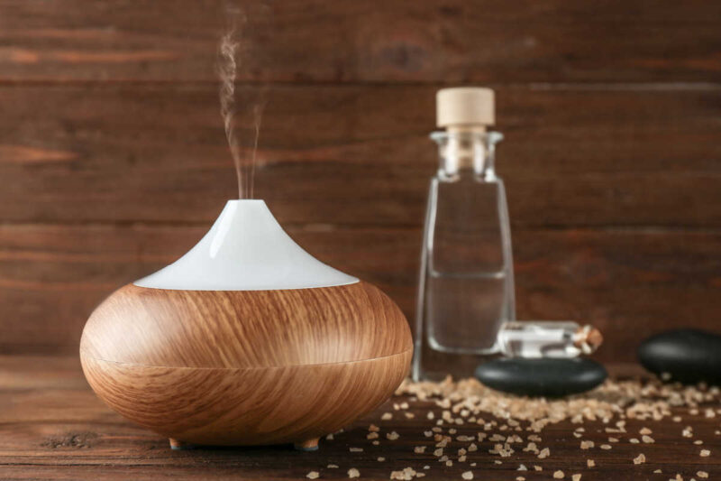 essential oil mist diffuser and a bottle of essential oil
