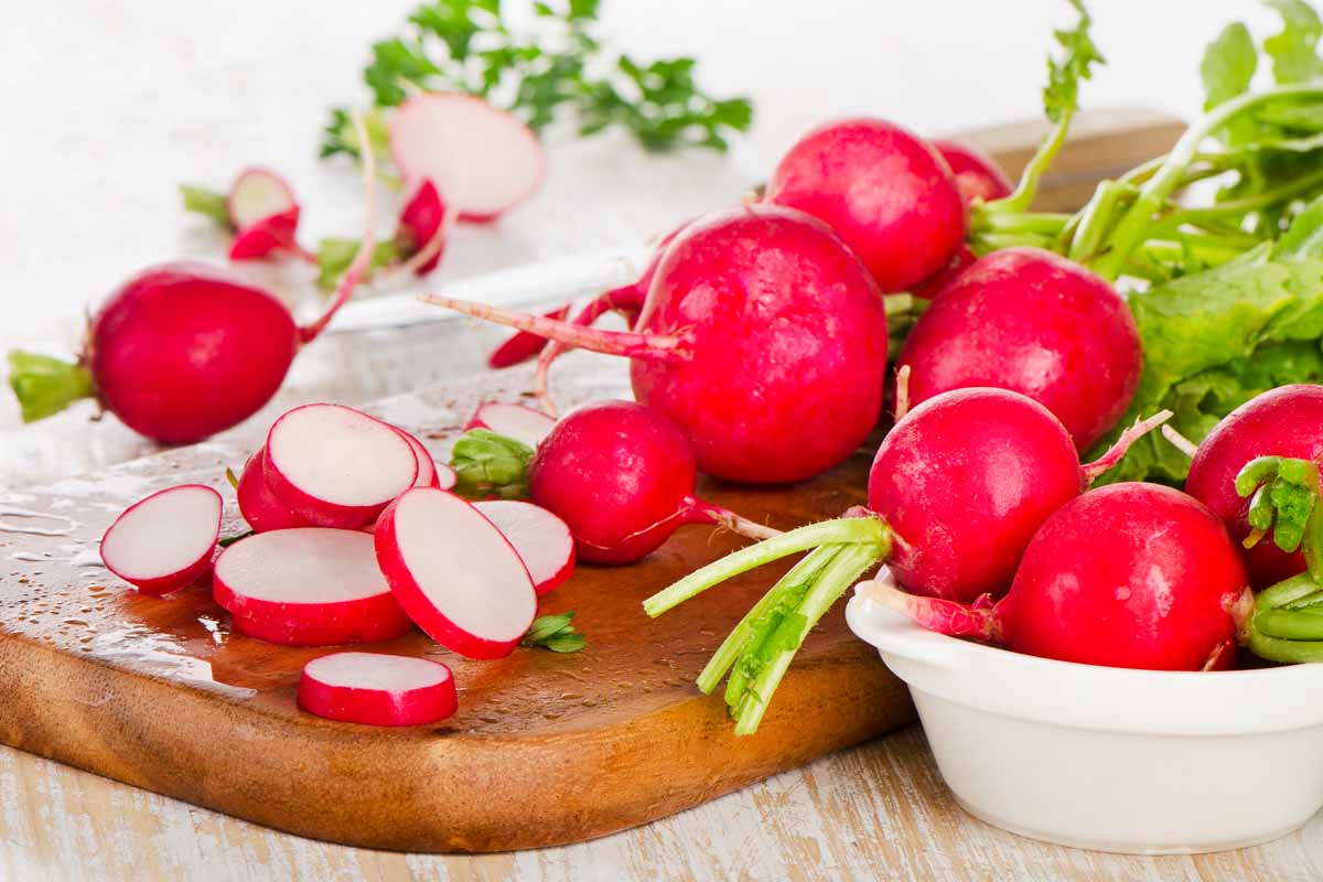 whole and sliced red radishes.