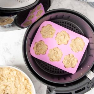 dog treats dough in a silicone mold in an air fryer basket.