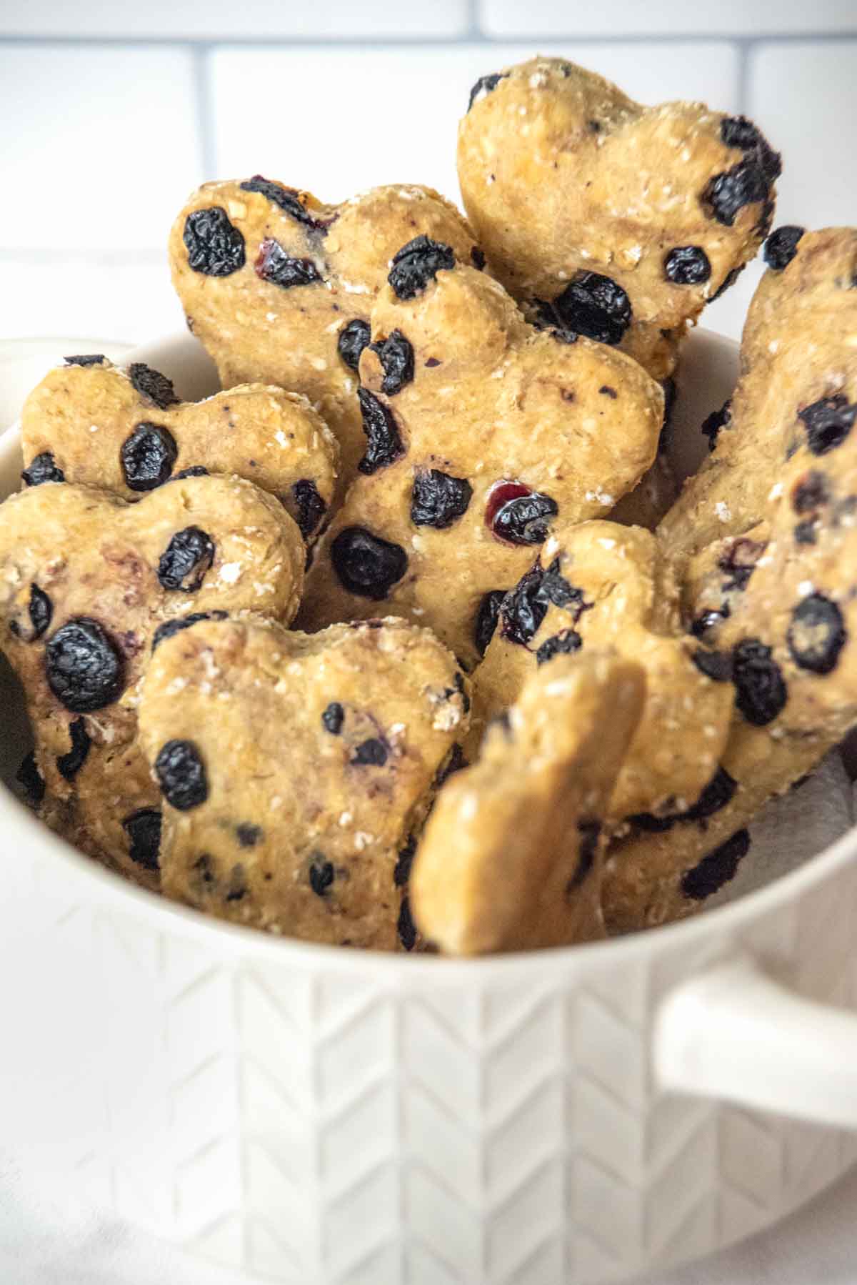 Homemade blueberry dog treats in a bowl.