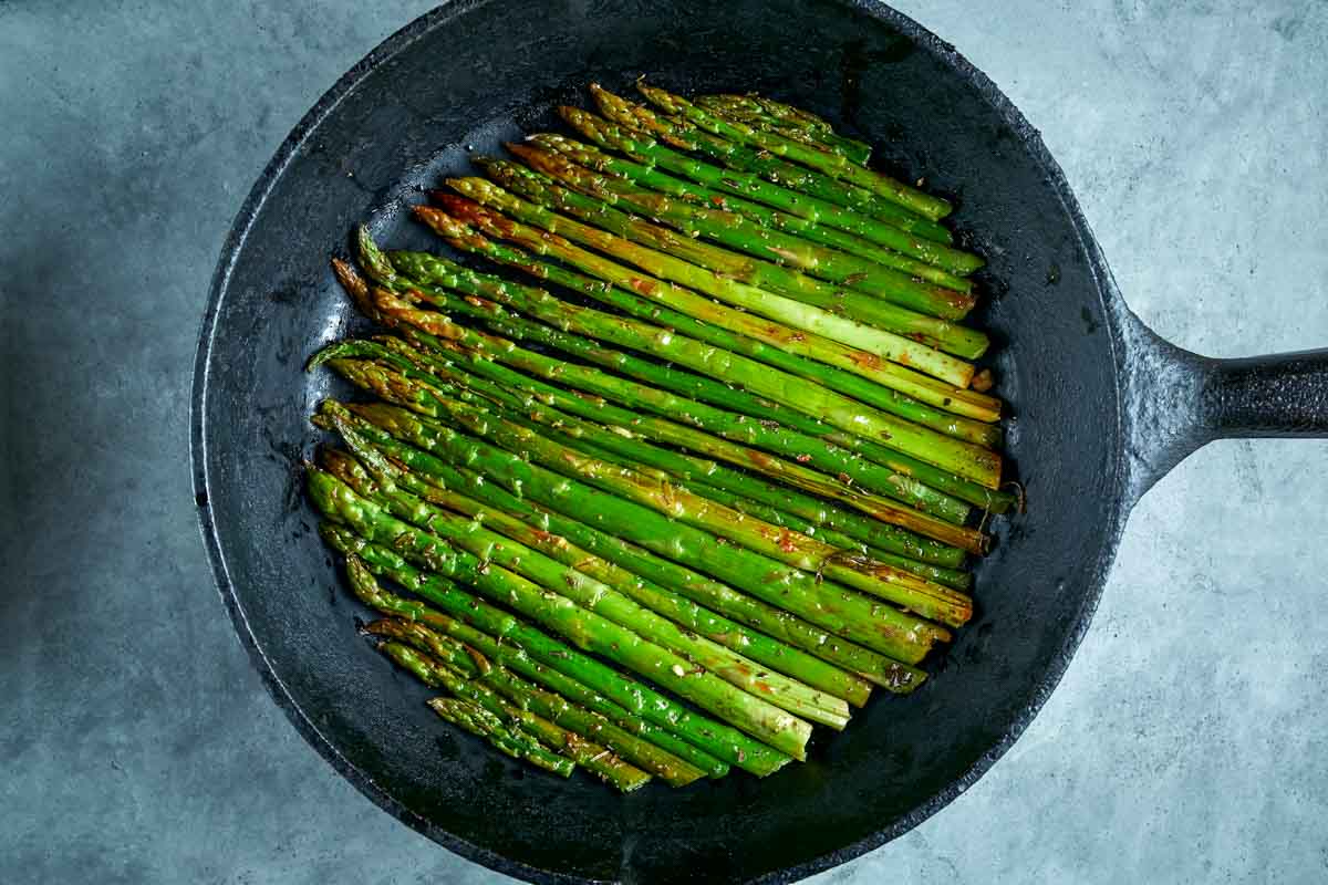 cooked asparagus in a skillet.