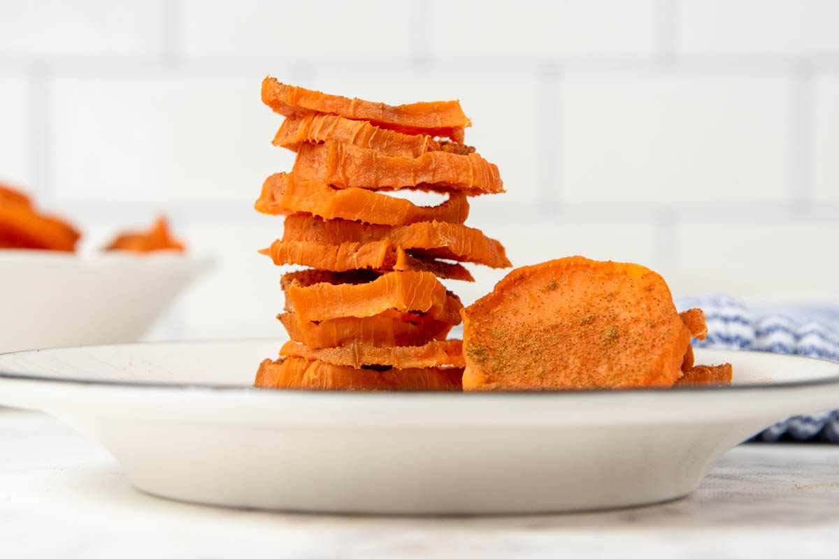 a stack of dehydrated sweet potato slices in a bowl.