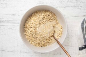 combining quick oats and brown rice flour in a bowl.
