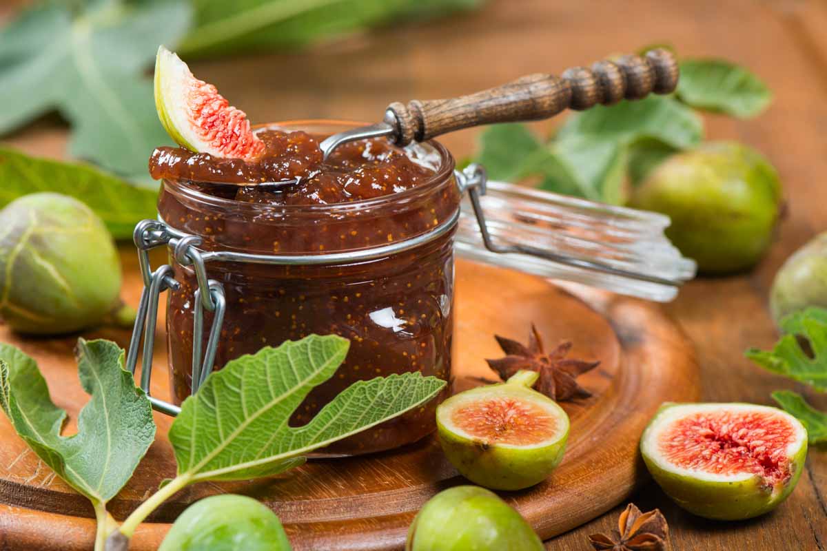 a jar of homemade fig jam and fresh figs.