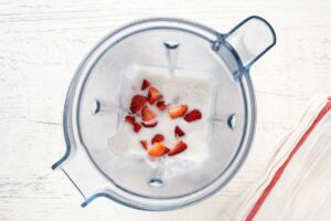 strawberries and coconut milk in a blender.
