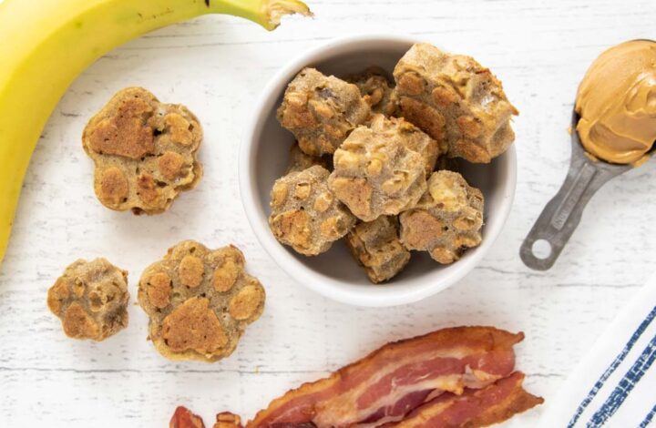 overhead view of homemade bacon dog treats, cooked bacon, banana, and peanut butter.