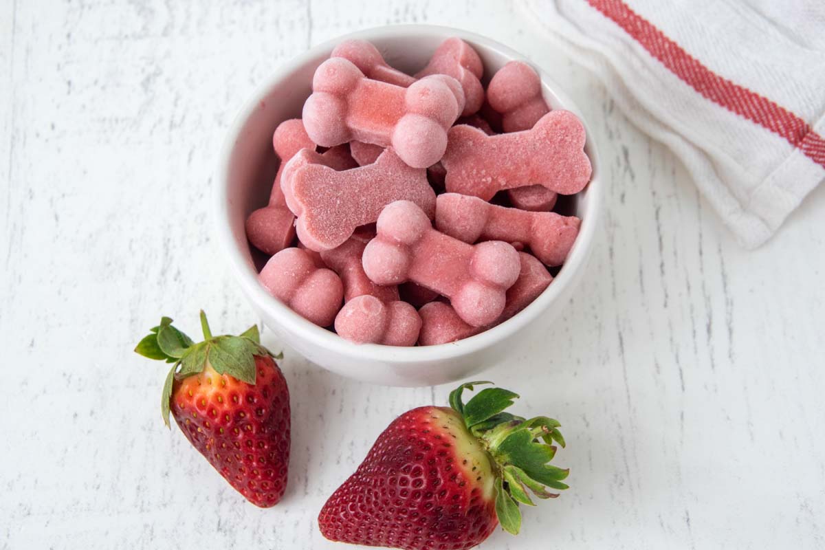 strawberry frozen dog treats in a bowl.
