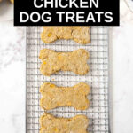 four homemade chicken dog treats on a wire rack.