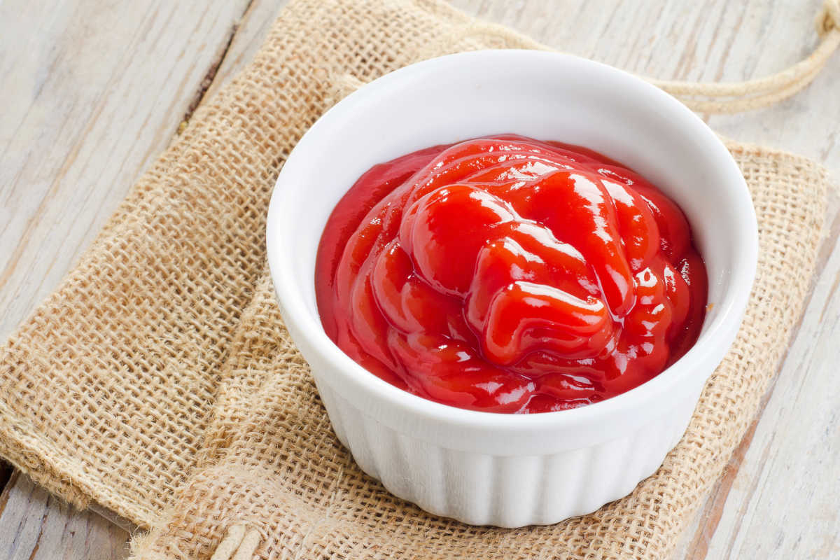 a bowl of ketchup on top of burlap.