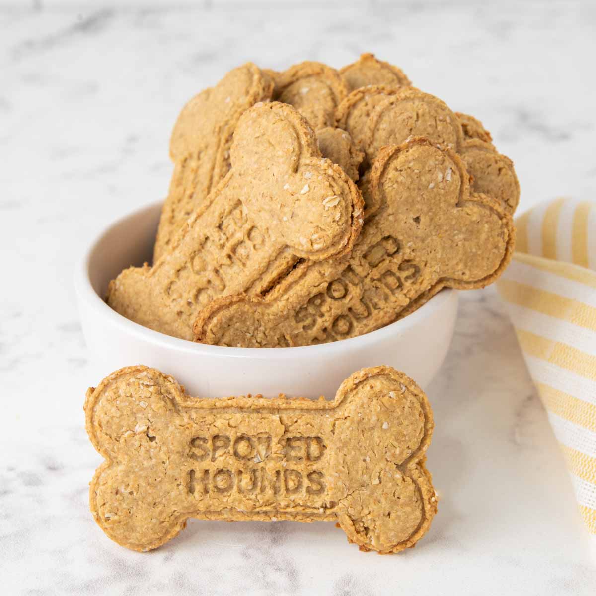bone shaped homemade peanut butter dog biscuits in a bowl.