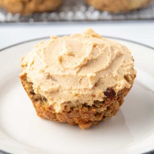 apple oatmeal pupcake with peanut butter frosting on a plate.