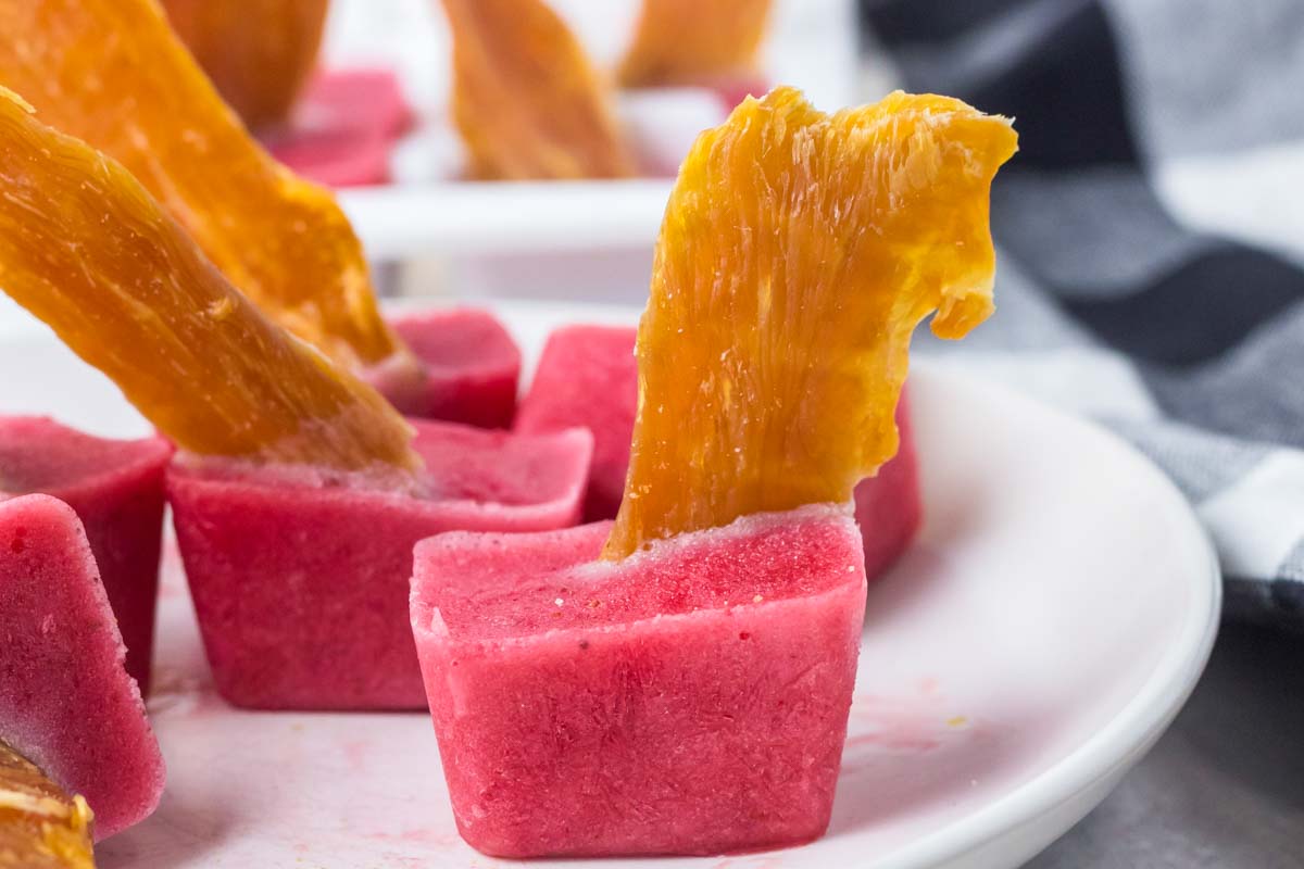 strawberry dog popsicles on a plate.