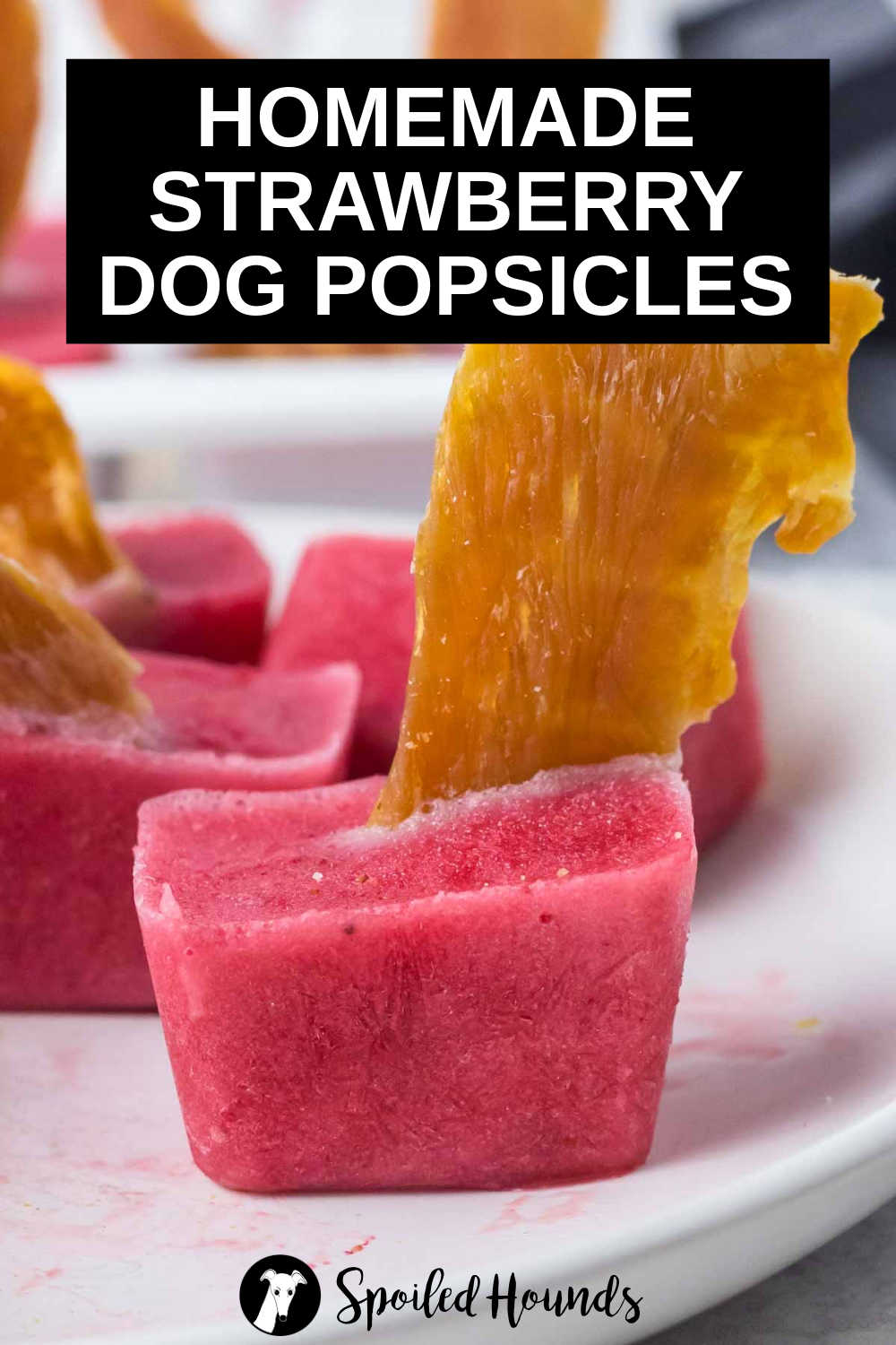 strawberry pupsicles on a plate.