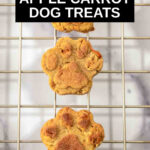 paw shaped apple carrot dog treats on a wire rack.