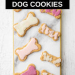 overhead view of iced peanut butter dog cookies on a marble board.