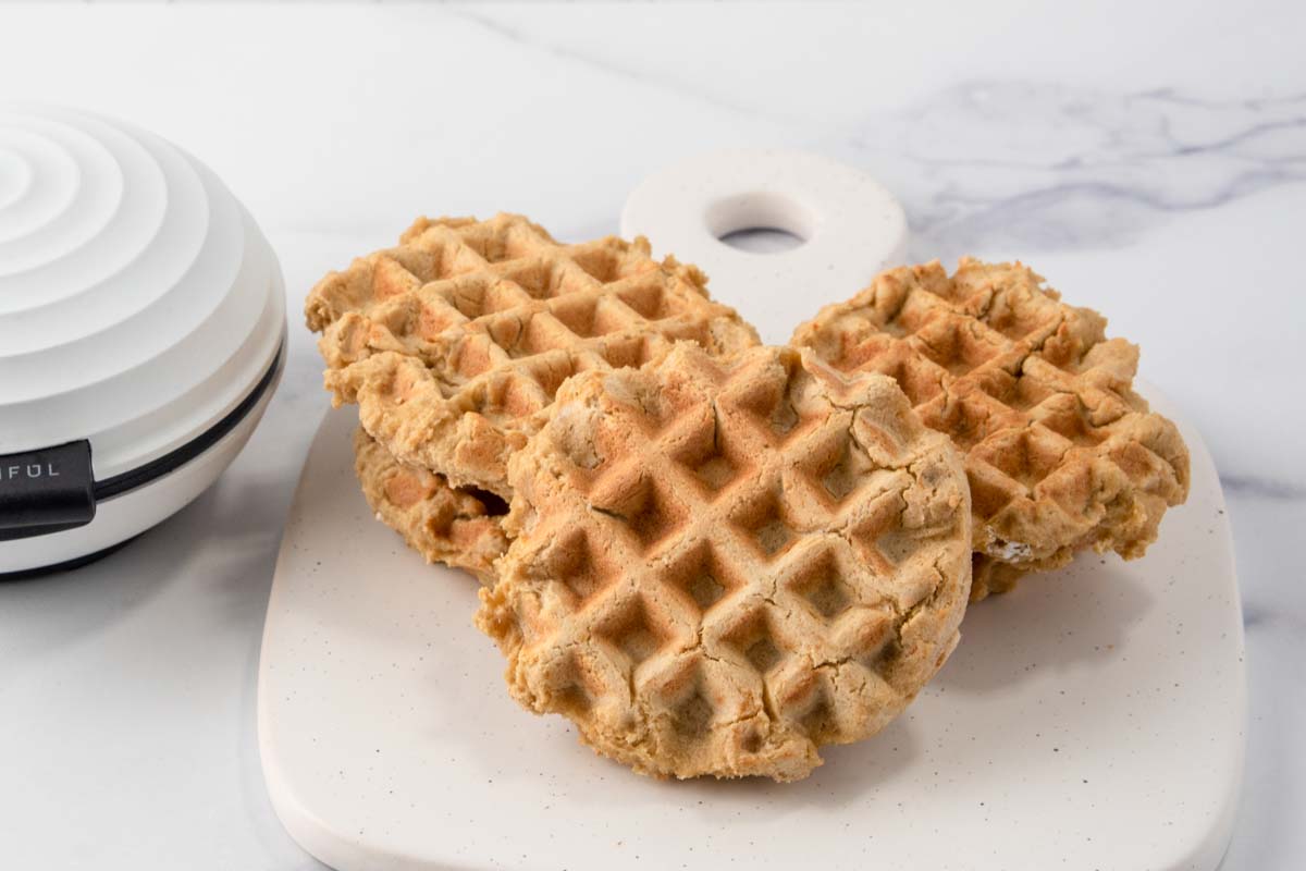 homemade dog waffles next to a mini waffle iron.