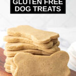 homemade gluten free dog treats stacked on a small wood board.