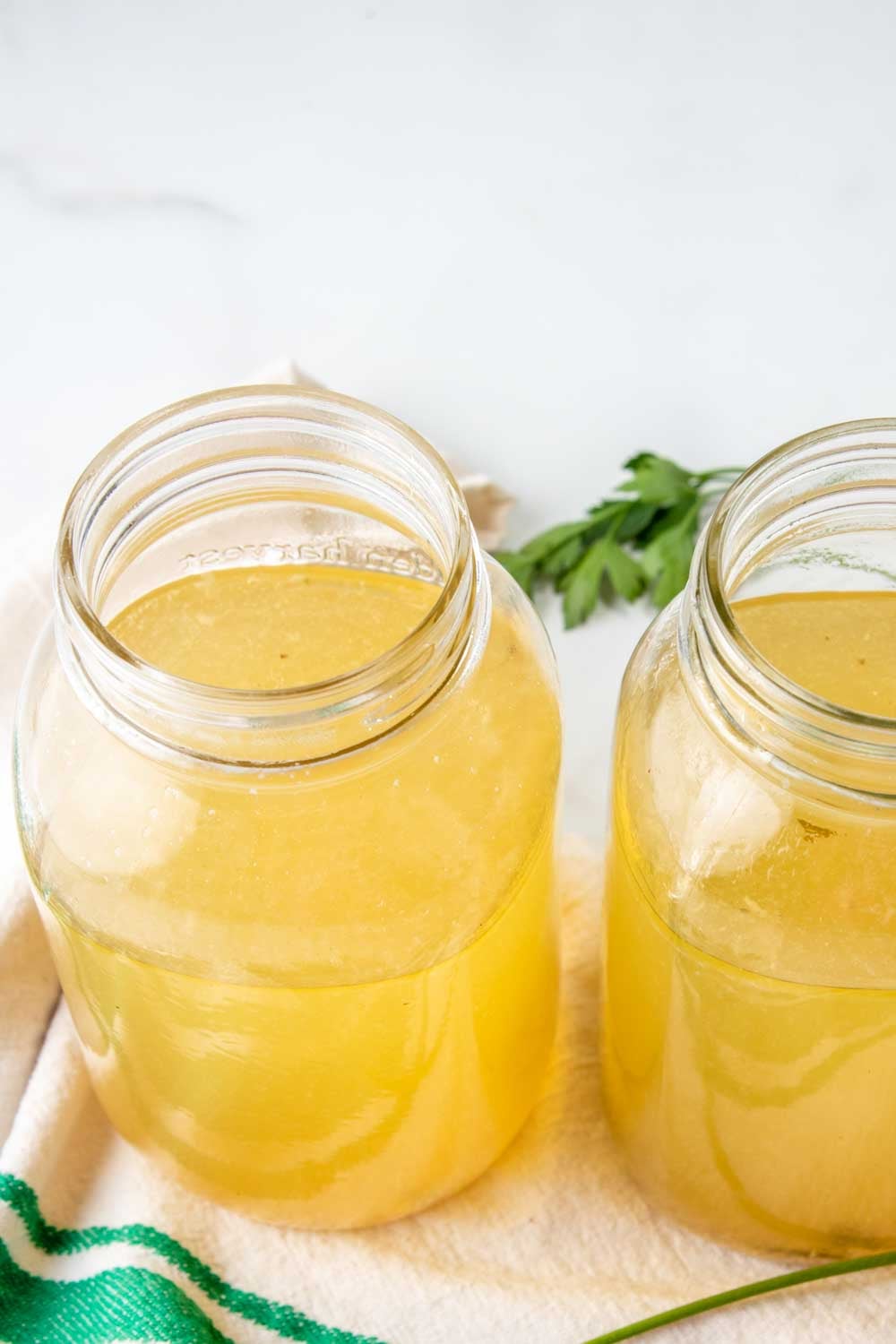 Homemade chicken and turkey bone broth for dogs in mason jars.