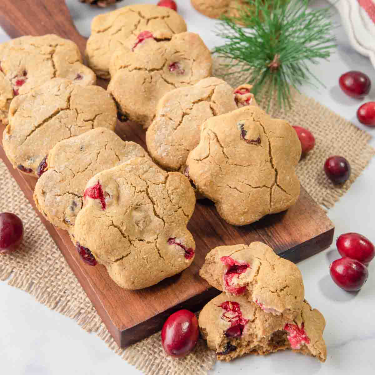 homemade cranberry dog treats on a small wood board.