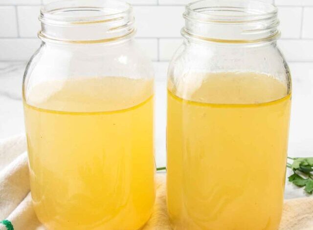 homemade bone broth for dogs in two mason jars.