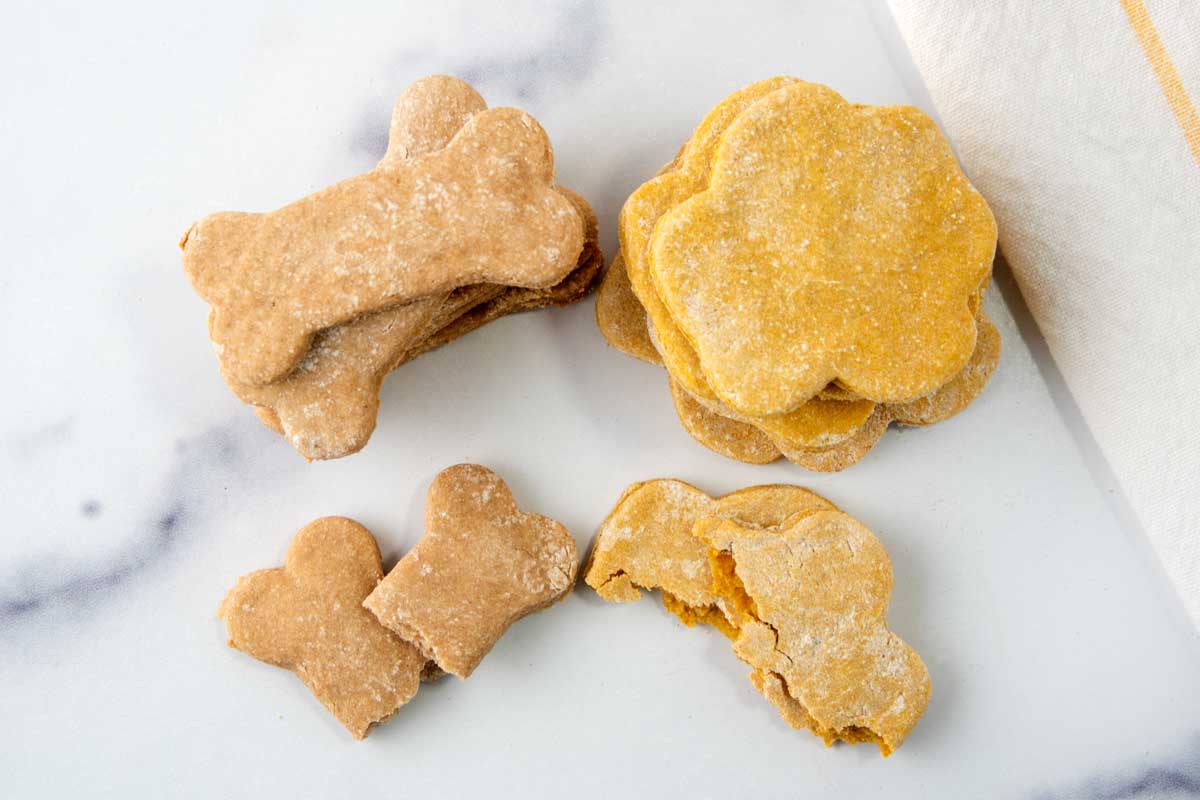 Two flavors of baby food dog treats in different shapes.