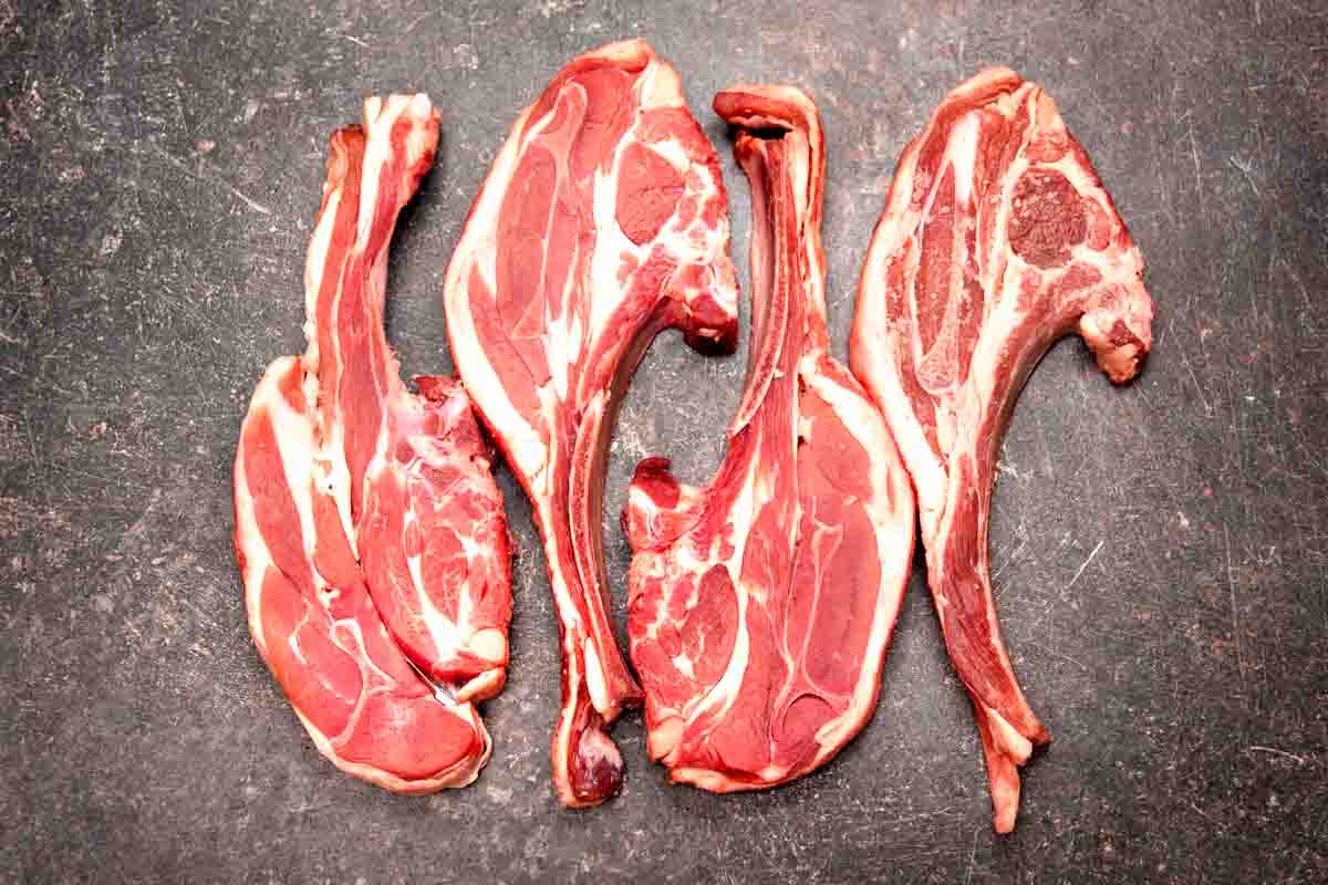 Four raw lamb chops.