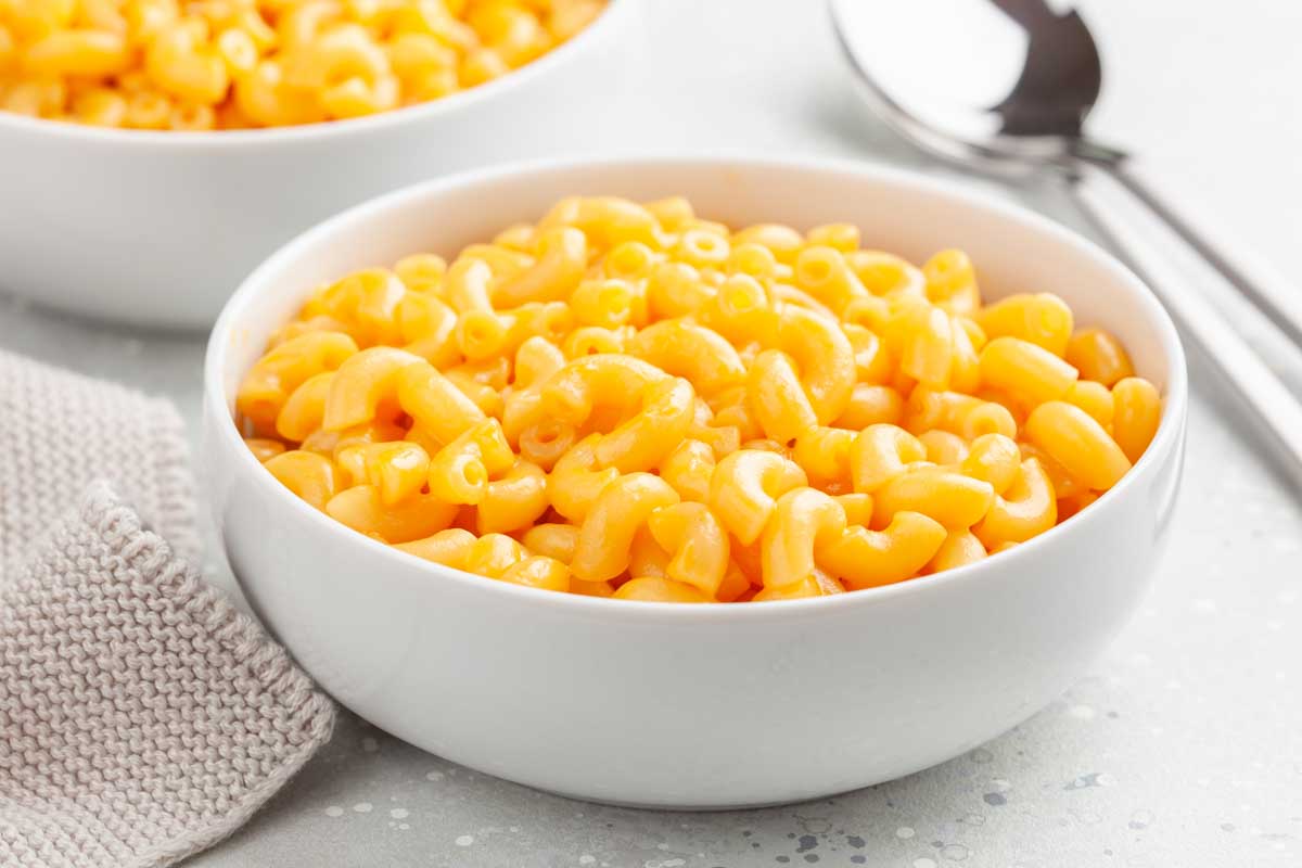 Mac and cheese in a white bowl.