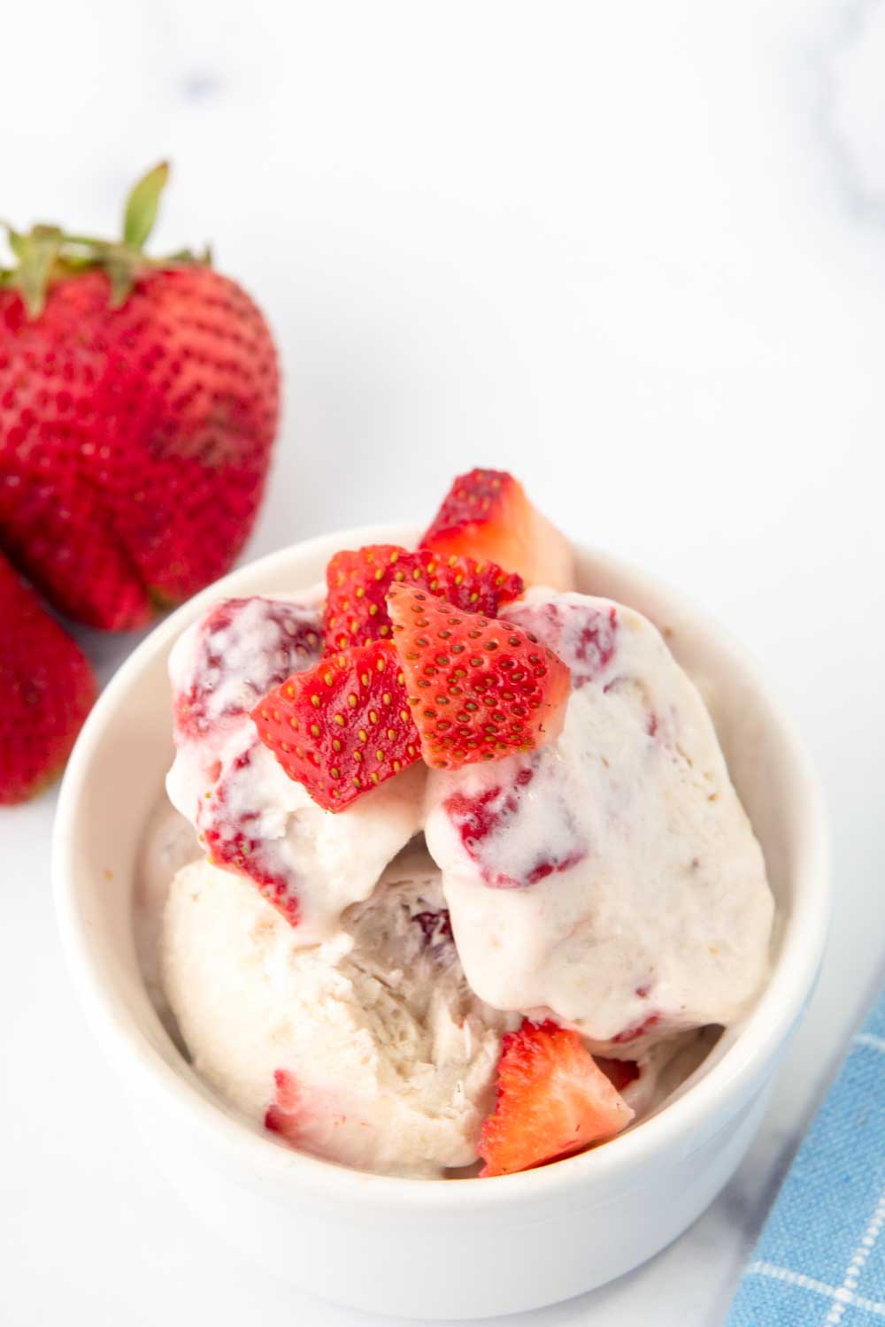 Strawberry banana dog ice cream in a white bowl.