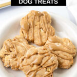 Four apple peanut butter dog treats on a white plate.