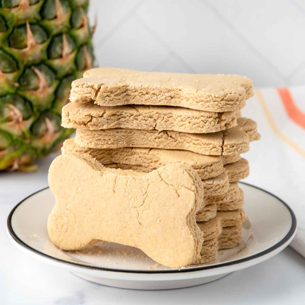 Homemade pineapple dog treats on a plate.