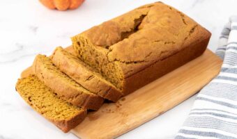 Homemade pumpkin bread for dogs on a cutting board.