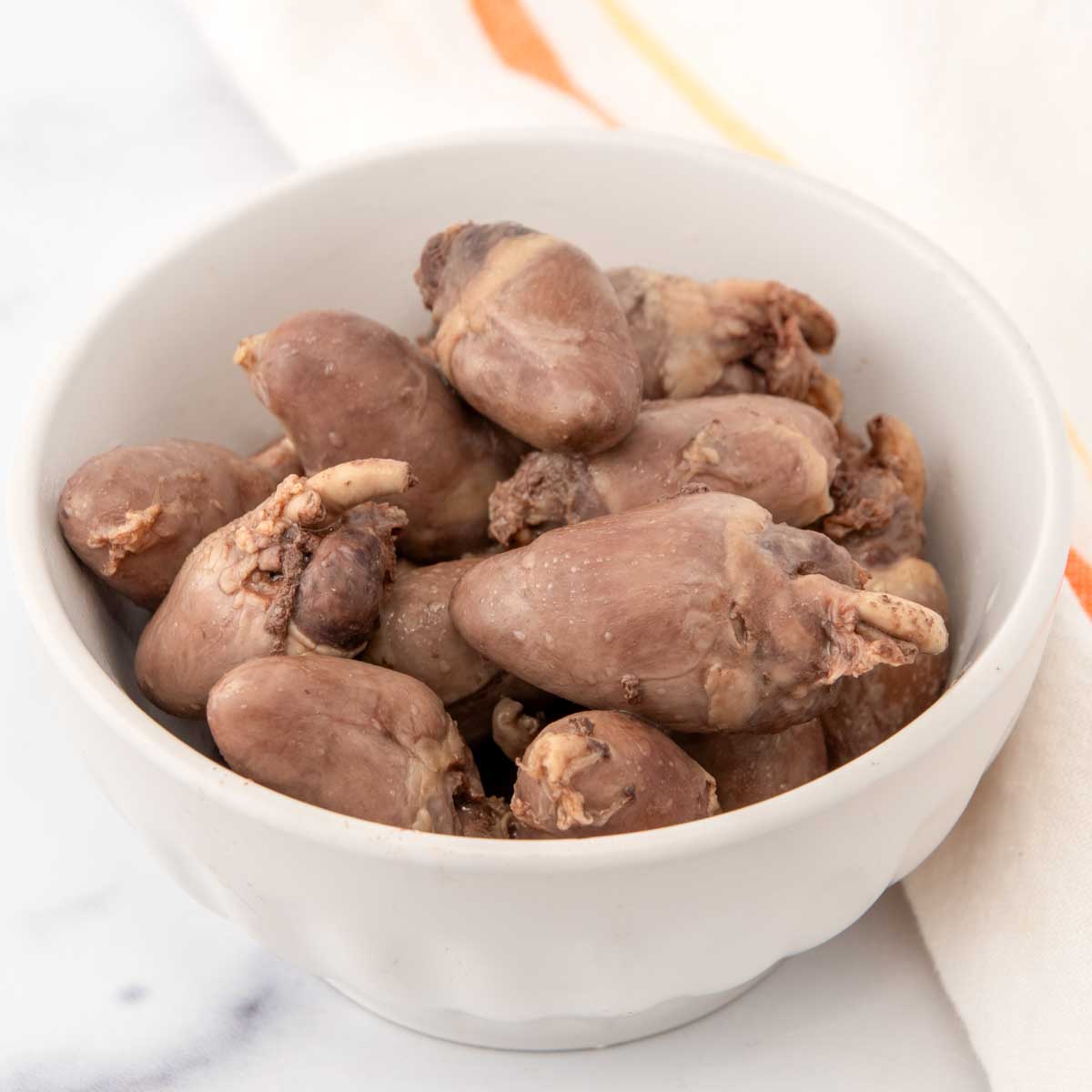 Homemade chicken hearts for dogs in a bowl.