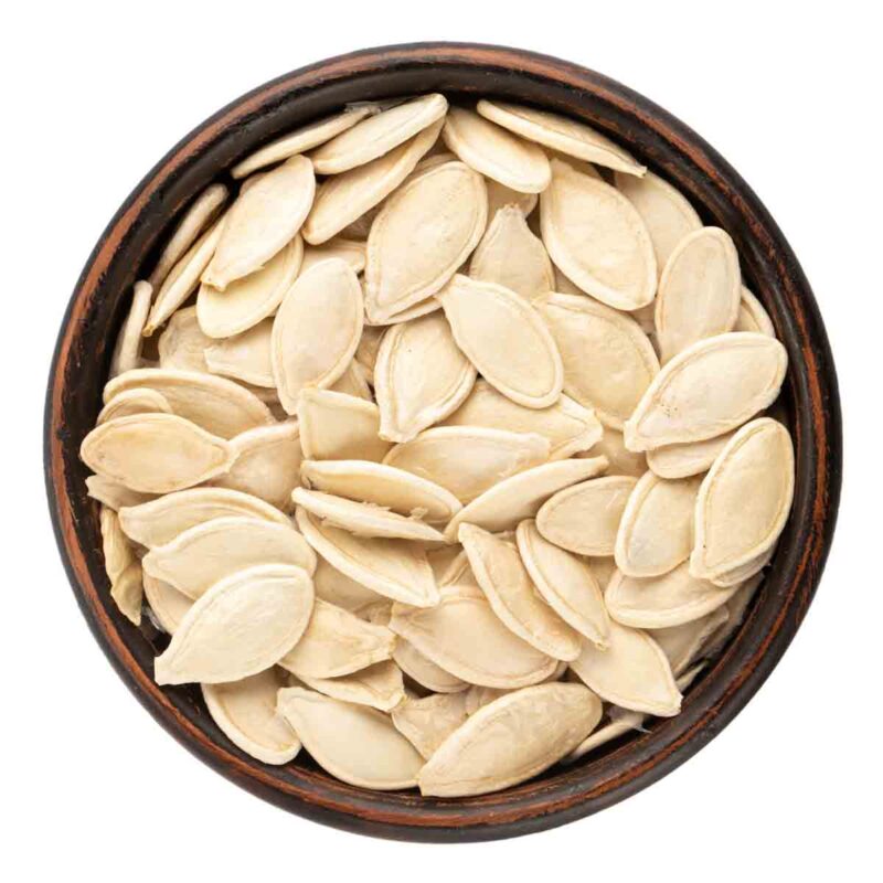 Raw pumpkin seeds in a bowl.