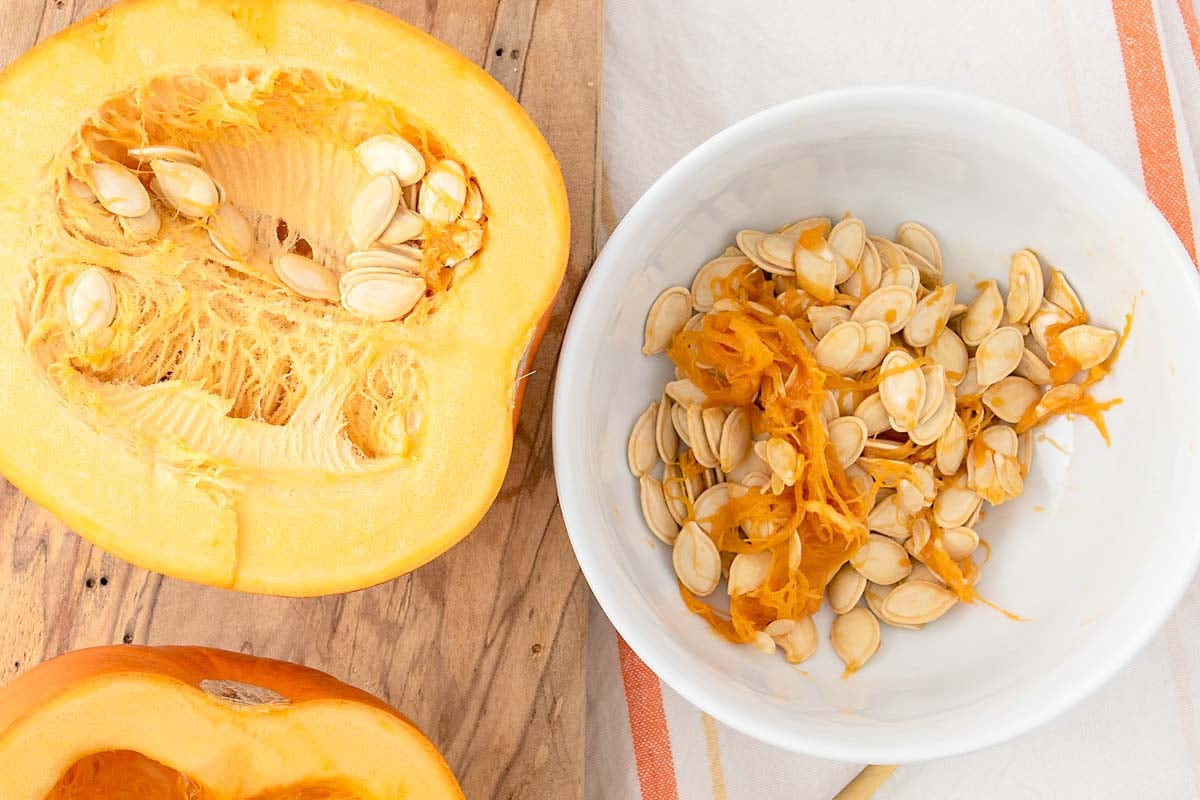 Fresh pumpkin seeds in a pumpkin and bowl.