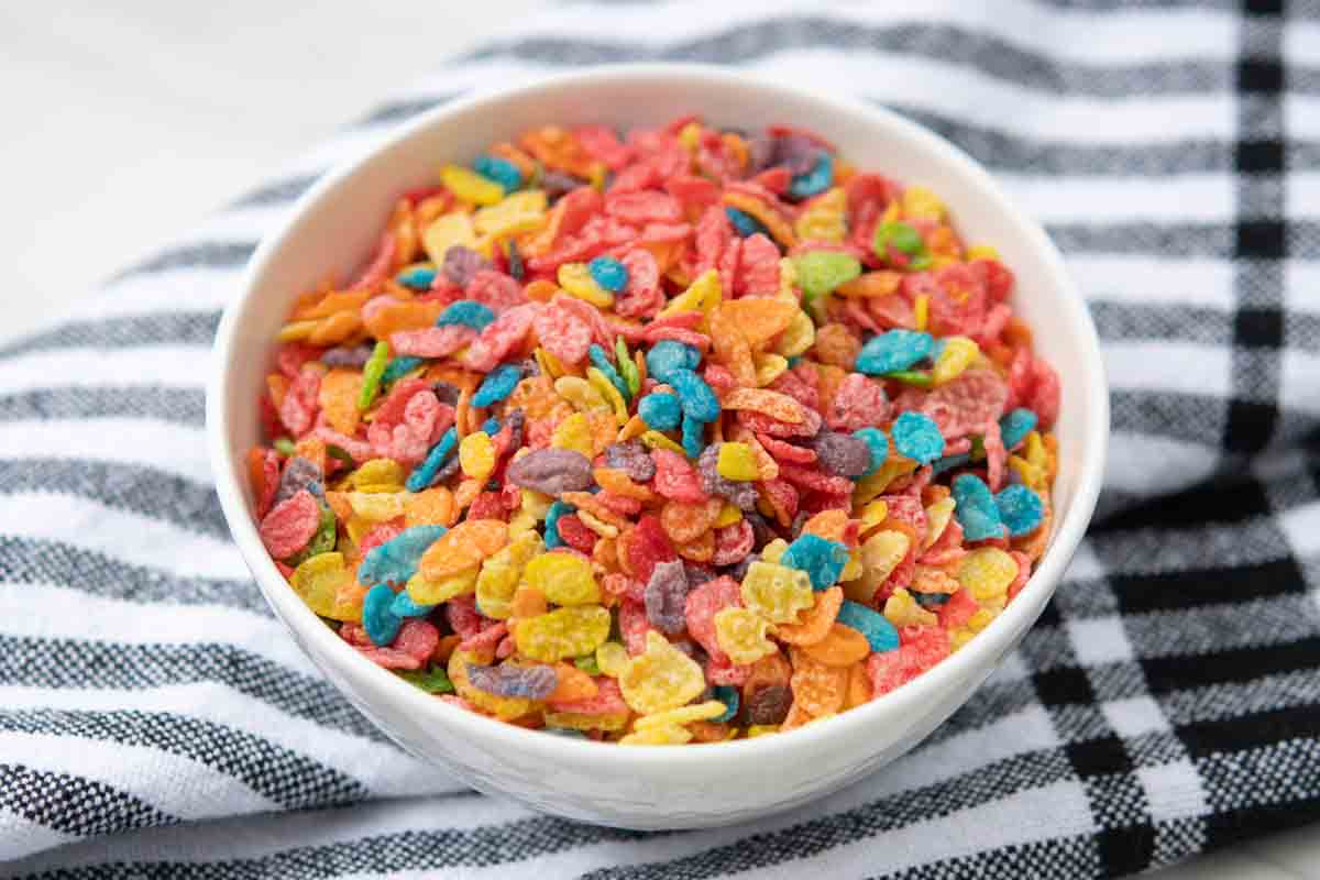 A bowl of Fruity Pebbles cereal on top of a kitchen towel.