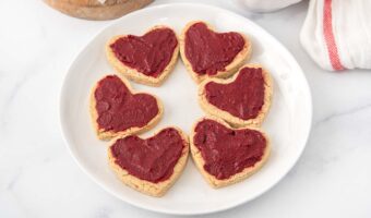 Homemade heart shaped valentine dog treats with icing.