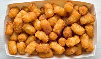 Tater tots in a paper serving tray.