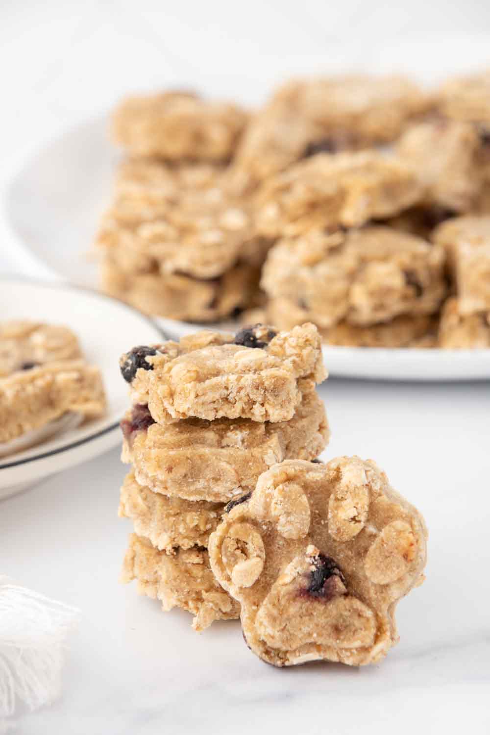 Homemade duck and blueberry dog treats in a stack and on a plate.