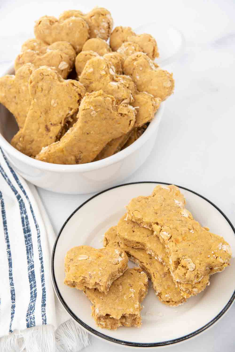 Homemade duck dog treats on a plate and in a bowl.
