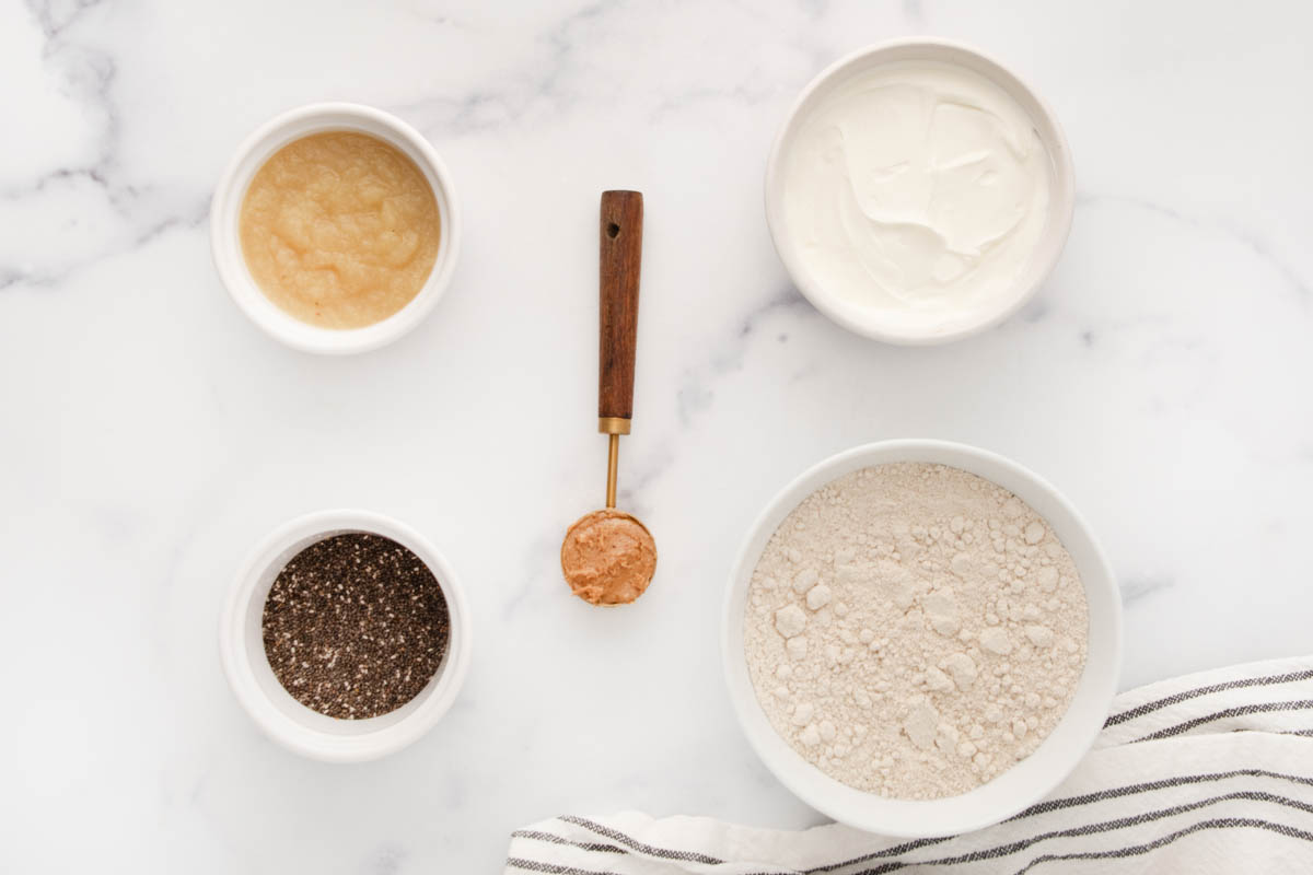 Homemade chia seed dog treats ingredients on a marble surface.