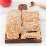 Homemade apple cinnamon dog treats on a wood board.