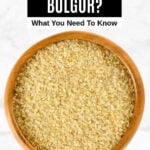 Uncooked bulgur in a wood bowl.