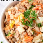 A bowl of homemade dog food with eggs garnished with parsley.