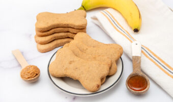Homemade honey dog treats in a stack and on a plate.