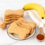 Homemade honey dog treats on a plate and in a stack.