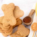 Homemade honey dog treats, honey in a spoon, and peanut butter in a spoon.