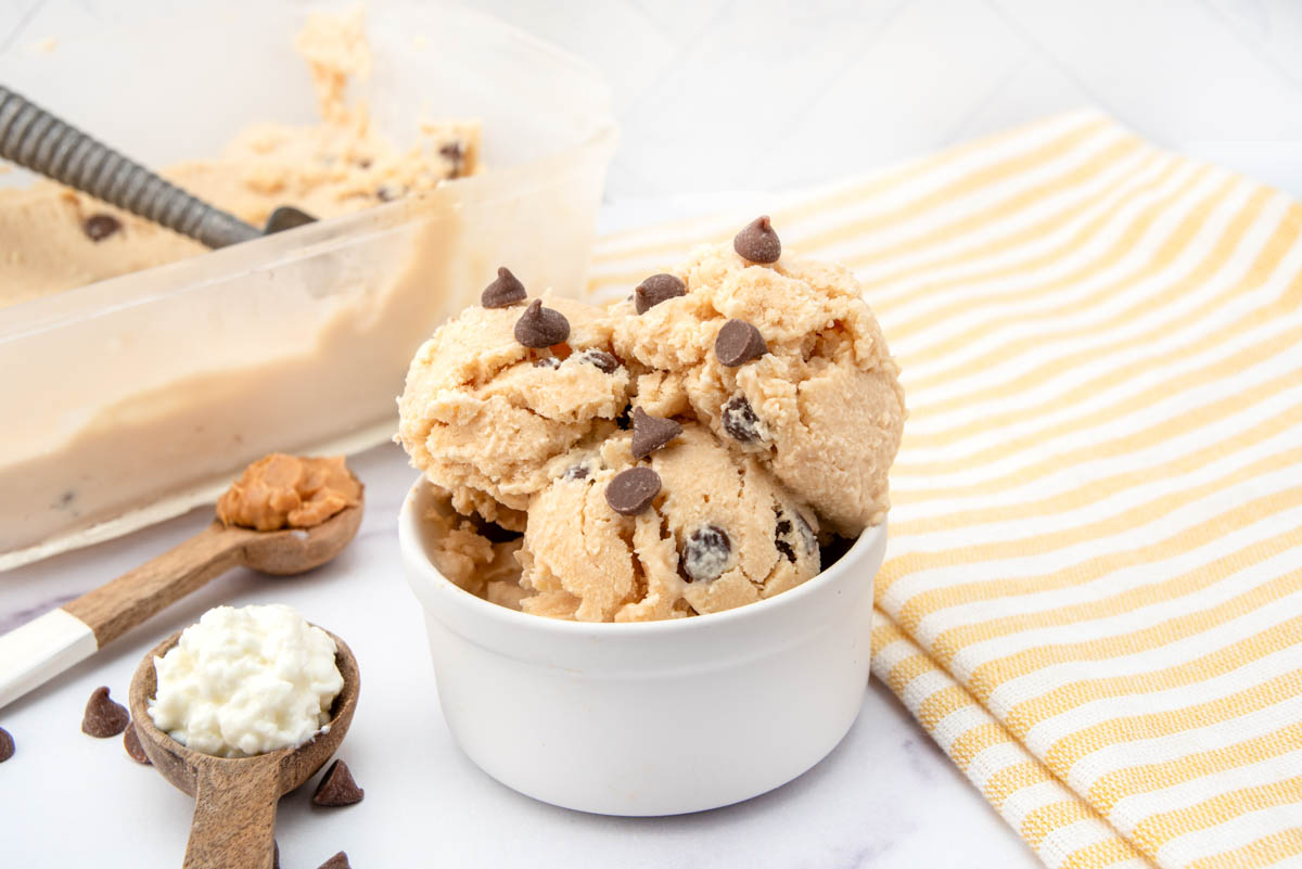Scoops of peanut butter cottage cheese ice cream for dogs in a small bowl.