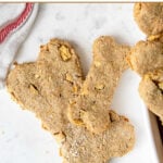 Two homemade bone shaped apple dog treats.